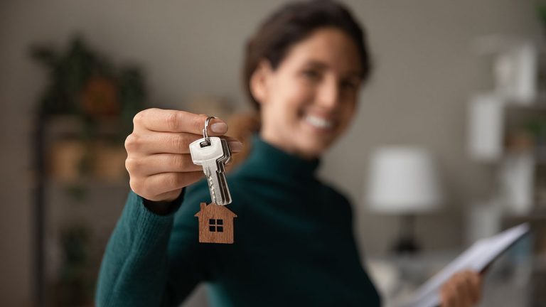 Woman in bristol holding keys for new property